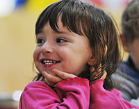 Young smiling girl with chin on hands